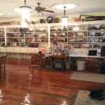 The pine wood floor as far as we know is the original floor.  We sanded it down, filled in the cracks, and replaced the badly worn boards with original boards from another part of the building.  We are unsure of the age of the shelving.