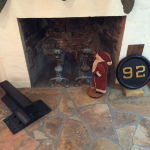 Fireplace after restoration.  Deborah's father took a chance and cut in with a concrete saw and hit the opening just right.  We didn't remove all of the concrete for fear of de-stabilizing the stone work.  The old brick work in the floor was replaced with flat rock.  Santa Claus is inspecting.