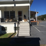 Side porch after restoration.  We moved the stairs to the side to open up the parking space out front and re-finished the concrete deck which was deteriorated.