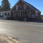 Store front after restoration.  Work included mortar repair, addition of deck and handicap ramp, custom made iron railing, and two swings for patients and local "old timers" to sit and reminisce and tell tales.  The swings replaced the "liars bench" that we are told used to be in front of the store.